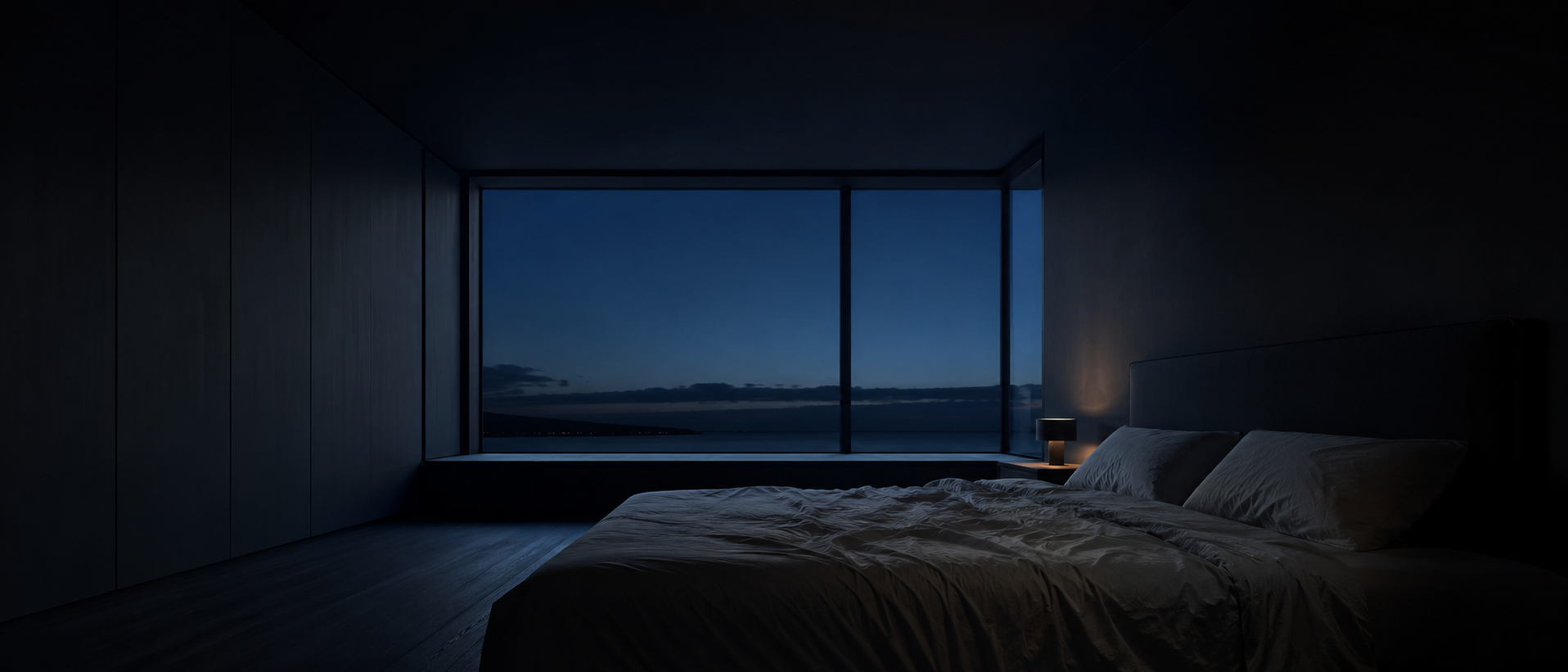 Dark minimal bedroom at night with floor-to-ceiling window and ocean view